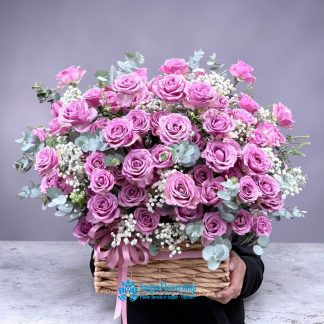 Basket of flowers in romantic purple tones