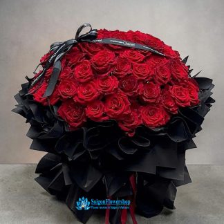 Romantic red roses wrapped in black paper