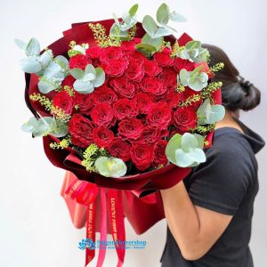 Simple bouquet of red roses interspersed with foliage